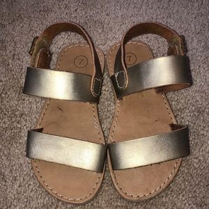 Gold strap sandals.